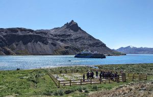 Un crucero expedici&oacute;n de los tantos que esperan esta temporada, y en primer plano visitantes a la tumba del explorador Sir Ernest Shackleton 