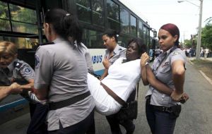 Mujeres policías empujaron y llevaron a las Damas de Blanco a colectivos en tanto los hombres fueron esposados y retirados en autos y camionetas policiales